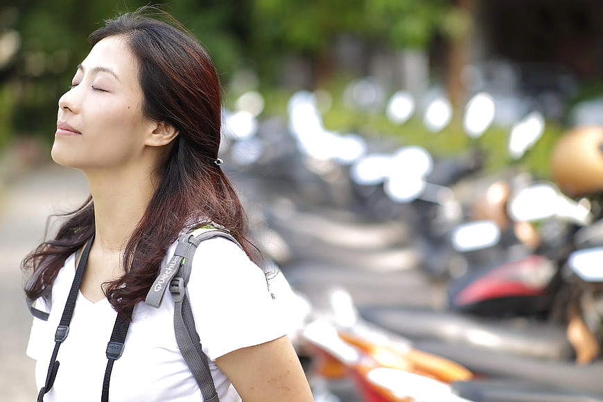 Serene Woman with Backpack in Urban Setting