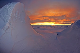 Arctic Sea Ice Landscape With Vibrant Orange Sunset Sky