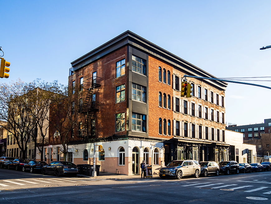 Corner Brick Building on Brooklyn Street with Parked Cars