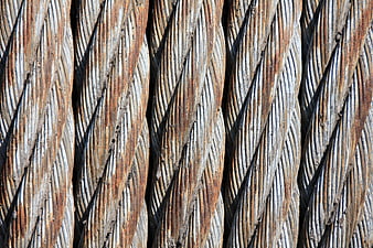 Close-up of rusty braided steel wire ropes texture