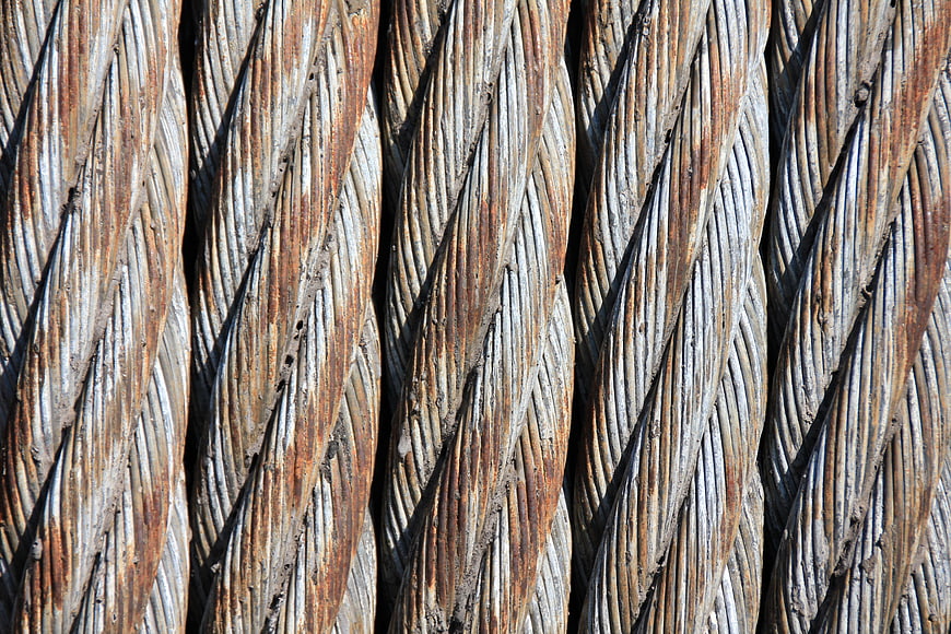 Close-up of rusty braided steel wire ropes texture