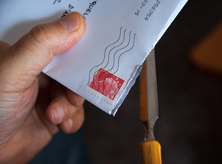 Hand Opening Envelope with Vintage Red Stamp