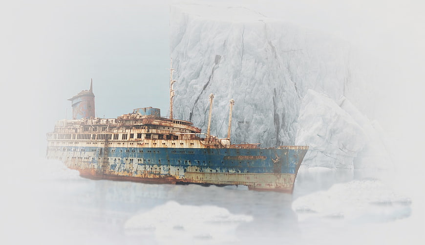 Rusty abandoned shipwreck stranded in arctic ice and fog