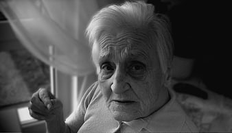 Black and white portrait of elderly woman with dementia in care home