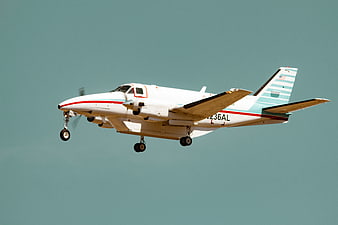 White Propeller Airplane Landing in Blue Sky