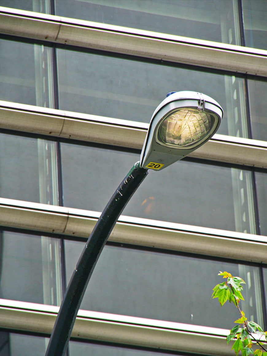 Modern Street Lamp Against Glass Building Facade