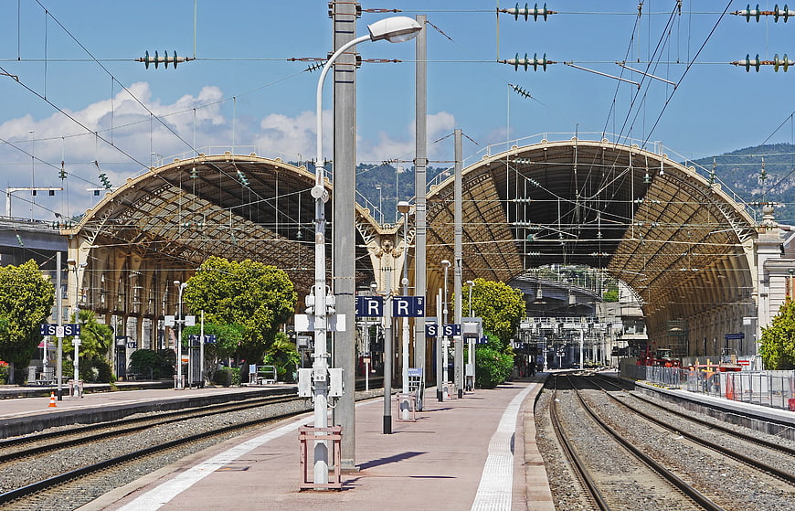 Empty Train Station Platform with Arched Canopy and Tracks