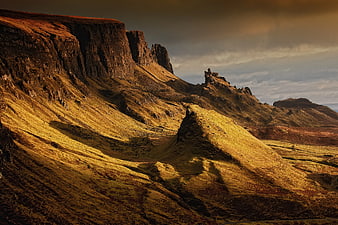 Dramatic Golden Light on Rugged Mountain Cliffs