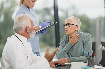 Senior woman consulting doctor about health concerns