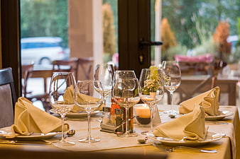 Elegant restaurant table setting with wine glasses and napkins