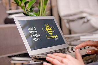 Laptop mockup with hands typing in office workspace