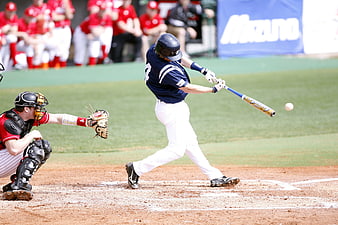 Baseball Batter Swinging at Pitch During Game