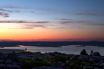 Scenic Sunset Over Rocky Lake Landscape