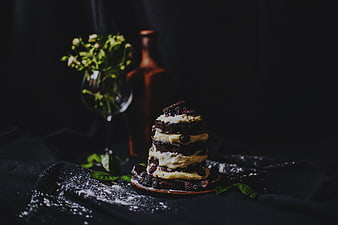 Dark moody blackberry cake with cream and greenery
