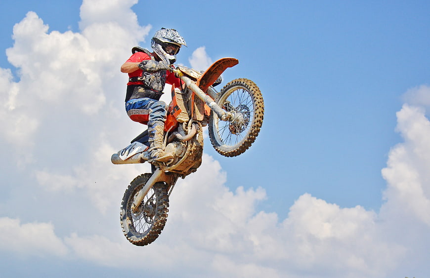 Motocross Rider Performing High Air Jump on Dirt Bike