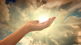Hand Reaching for Sunlight Through Clouds