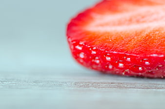 Close-up of fresh sliced strawberry on wooden surface