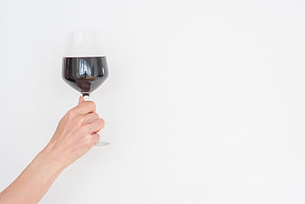 Hand Holding Red Wine Glass on White Background