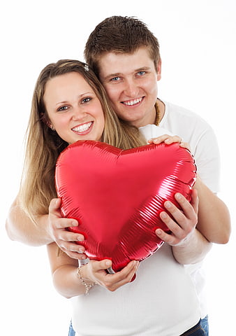 Happy Young Couple Holding Red Heart Balloon on White Background