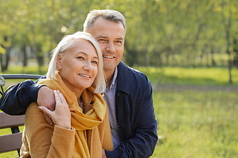 Happy Senior Couple Embracing on Park Bench