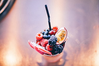 Overhead view of berry smoothie with fresh fruit garnish