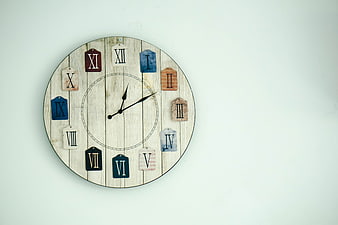 Rustic Wall Clock With Roman Numerals On White Wall