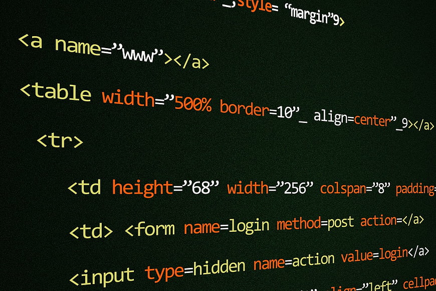 Close-up of HTML code on dark screen