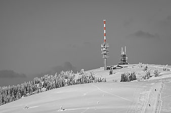 Snowy Mountain Peak with Communication Towers in Winter