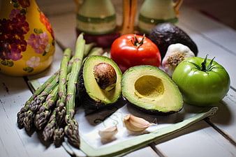 Fresh Avocado, Asparagus, and Tomatoes on Wooden Table
