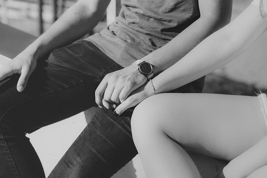Black and white photo of couple holding hands