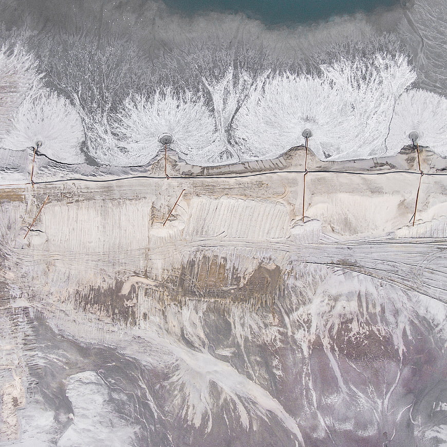 Aerial view of snow-covered mountain landscape with ski lift towers