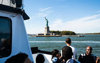 Tourists on Ferry Viewing Statue of Liberty in New York Harbor