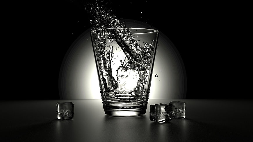 Dynamic Splash of Water Pouring into Glass with Ice Cubes
