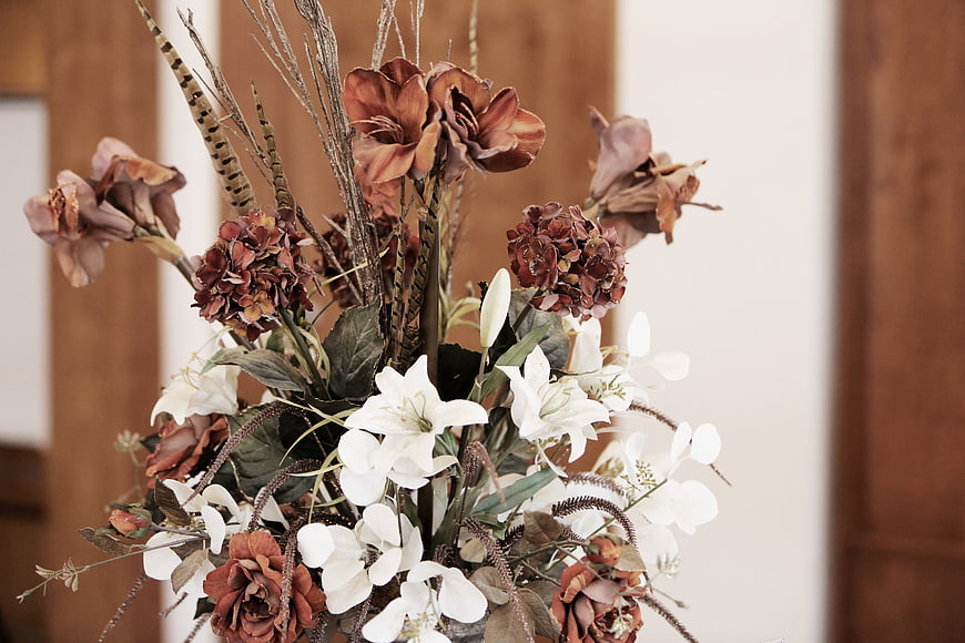 Rustic floral arrangement with white lilies and dried brown flowers
