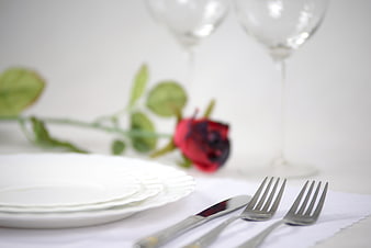 Romantic Dinner Table Setting with Red Rose and Silverware