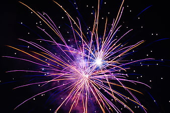Vibrant multicolored fireworks exploding in night sky
