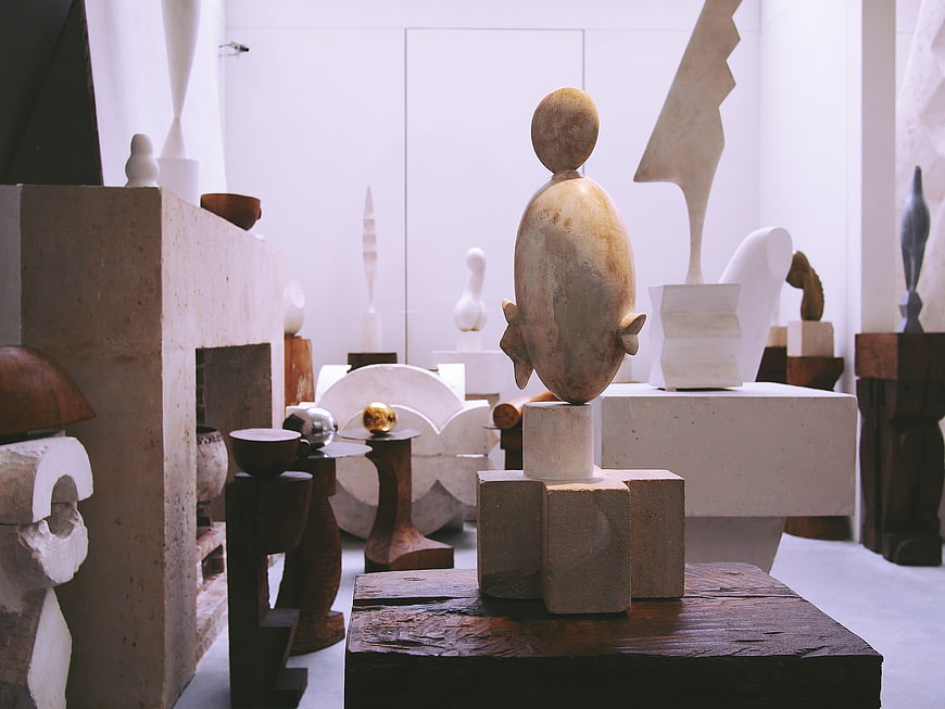 Abstract wooden and stone sculptures in a gallery