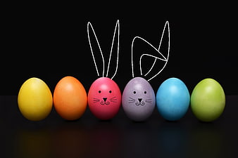 Colorful Easter Eggs with Bunny Ears on Black Background