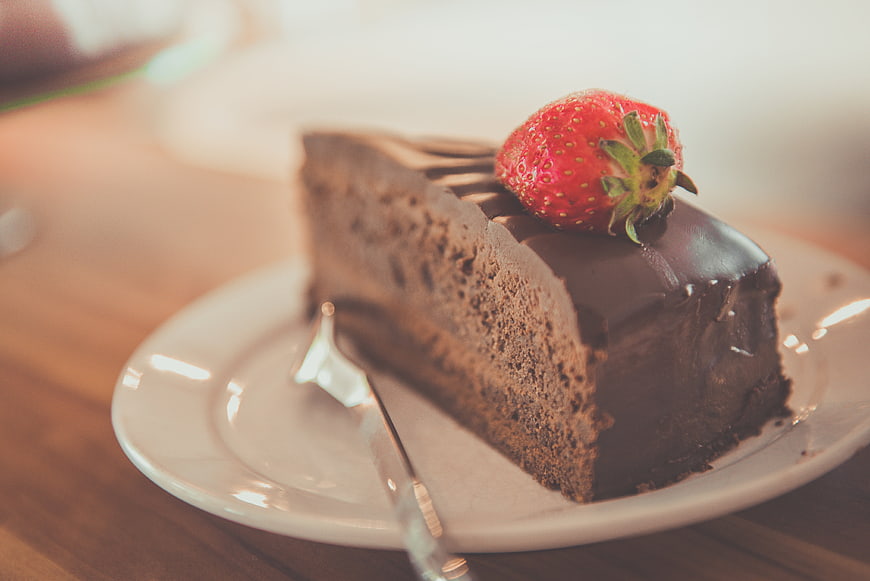 Chocolate Cake Slice with Strawberry on White Plate