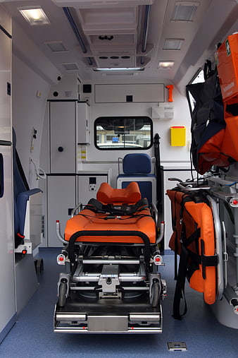 Interior of modern ambulance with orange stretcher and medical equipment