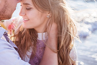 Romantic couple close-up with woman smiling and man touching forehead