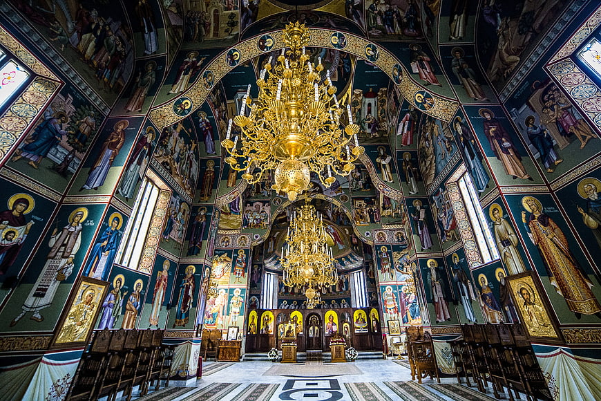 Interior of Orthodox Church with Gold Chandeliers and Frescoes