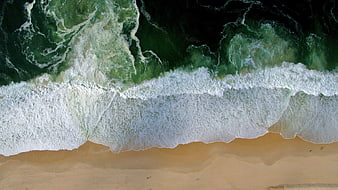 Aerial View of Ocean Waves Crashing on Sandy Beach