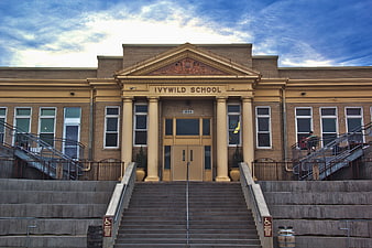 Front view of Ivywild School building with stairs and columns