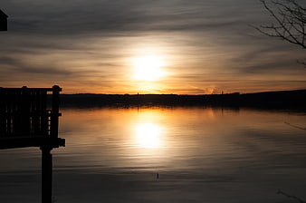 Serene Sunset Over Lake with Silhouetted Dock