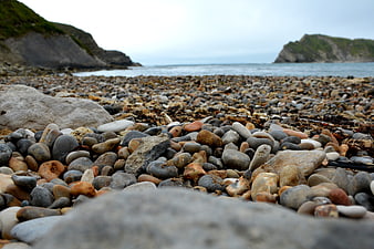 Low angle view of pebbles on a rocky coastal beach