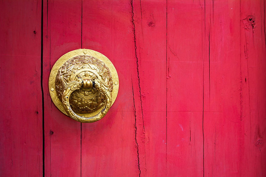 Golden Dragon Door Knocker on Red Wooden Door