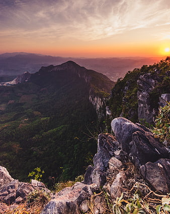 Dramatic Mountain Ridge Sunset with Rocky Foreground