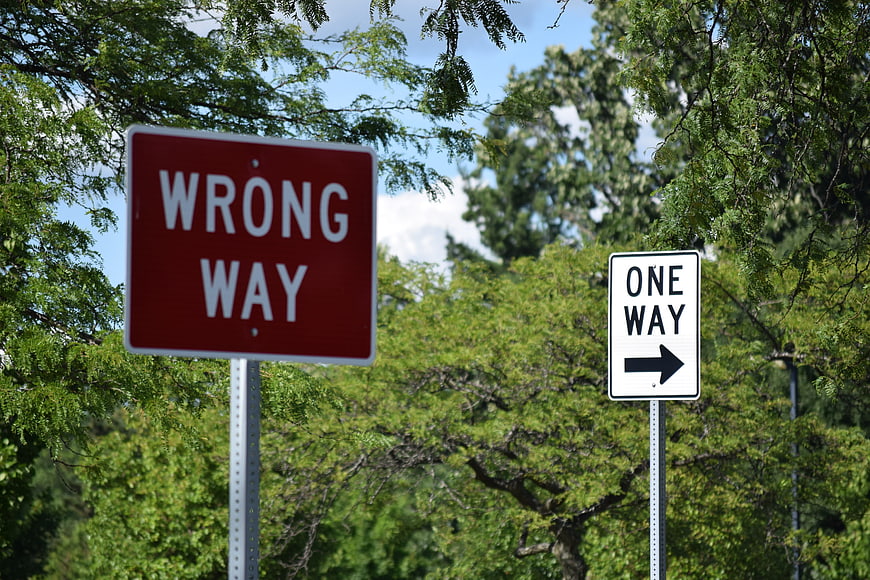 Red Wrong Way and White One Way Street Signs