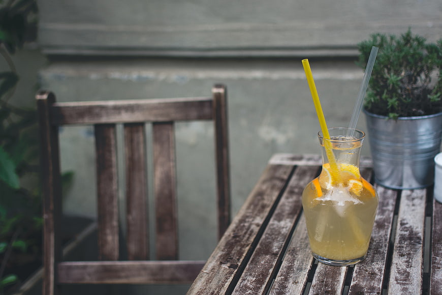 Refreshing orange lemonade pitcher on rustic wooden table